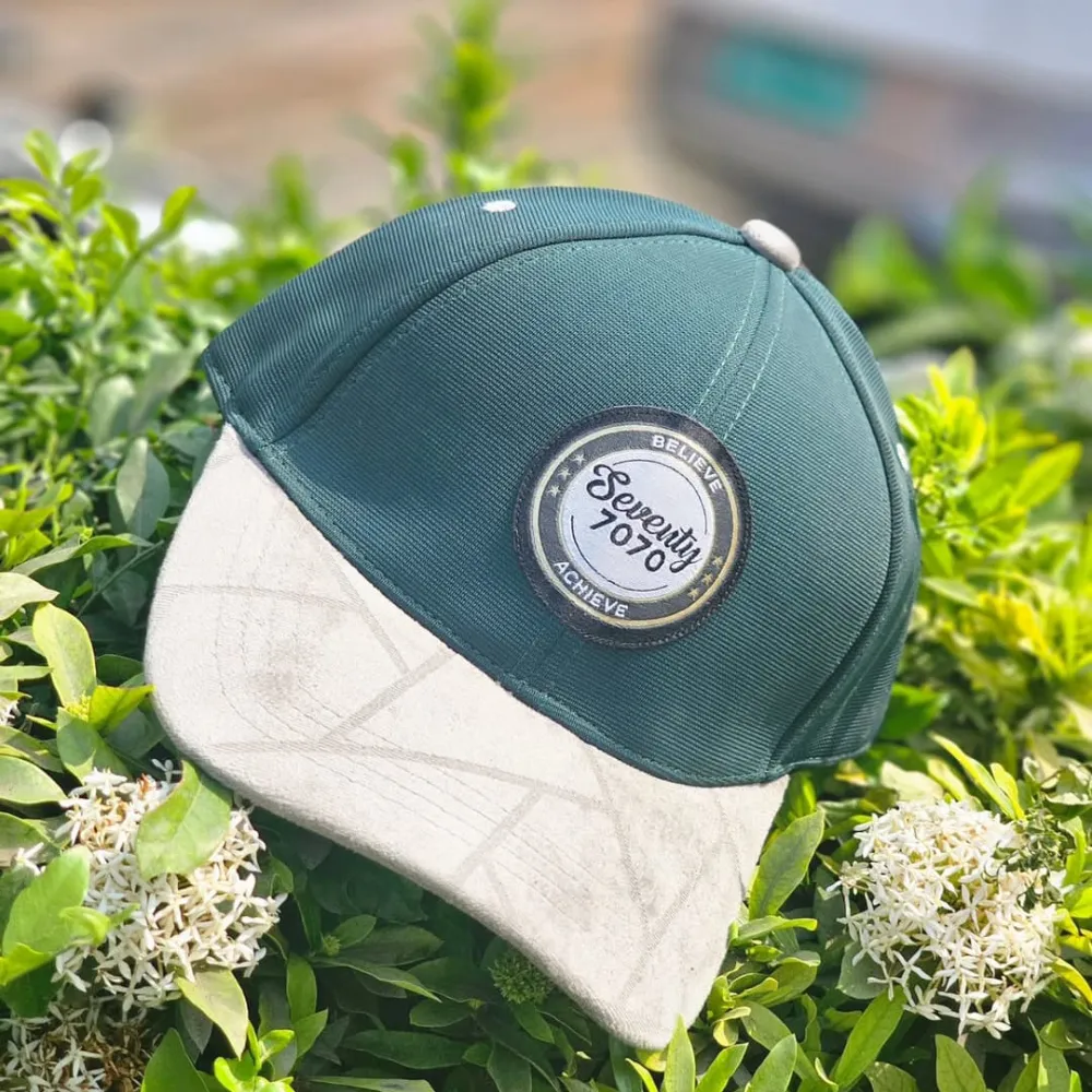11Sports light blue India 7070 trucker cap with breathable white mesh resting outdoors.