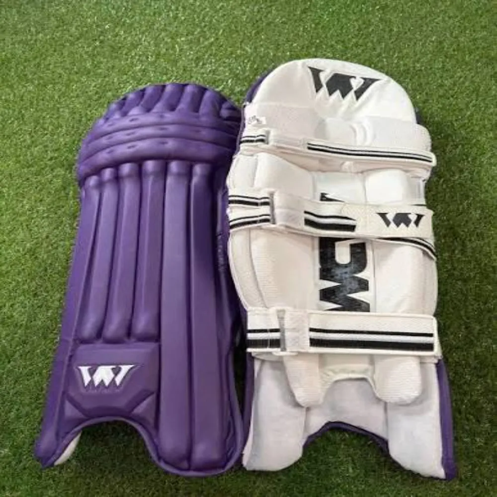 Pair of 11Sports purple cricket batting pads showing front face and padded back straps on artificial turf.