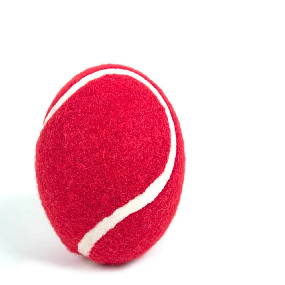 Single 11Sports deep red heavy tennis cricket ball with white curved seam on a white background.