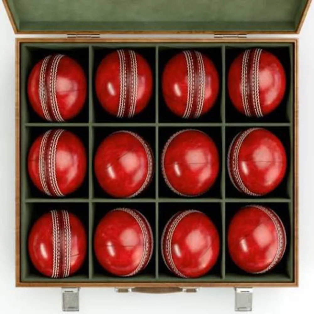 Wooden presentation box containing twelve 11Sports hand-stitched red leather match cricket balls.