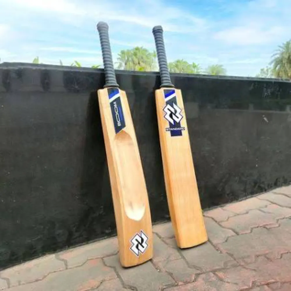 Pair of 11Sports Boom hard tennis cricket bats with aerodynamic rear scoop and ribbed grey grips.