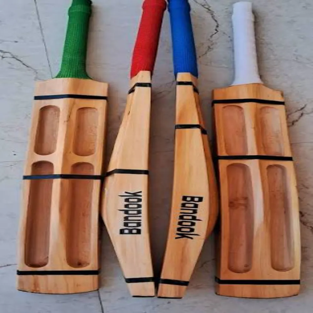 Set of four 11Sports Bandook carved tennis cricket bats with green, red, blue, and white grips.